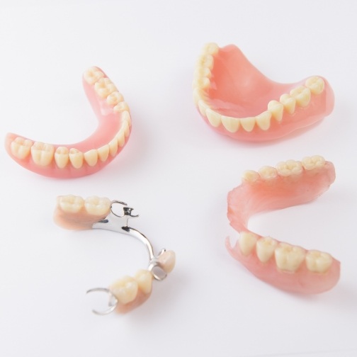 Two full dentures and two partials against white background