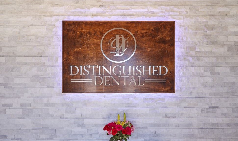 Distinguished Dental sign on wall of Fort Worth dental office