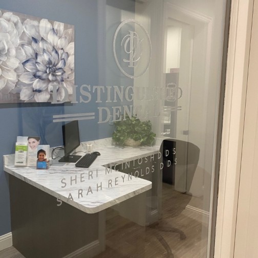 Glass door with the Distinguished Dental logo