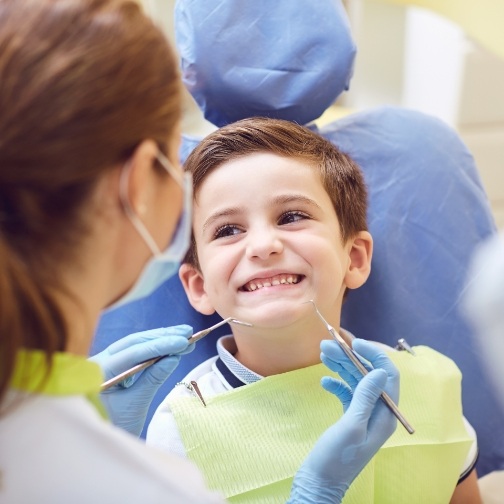 Young boy smiling at his childrens dentist in Fort Worth