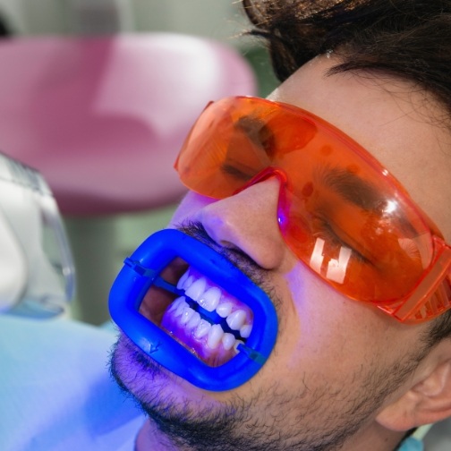 Man in dental chair getting professional teeth whitening