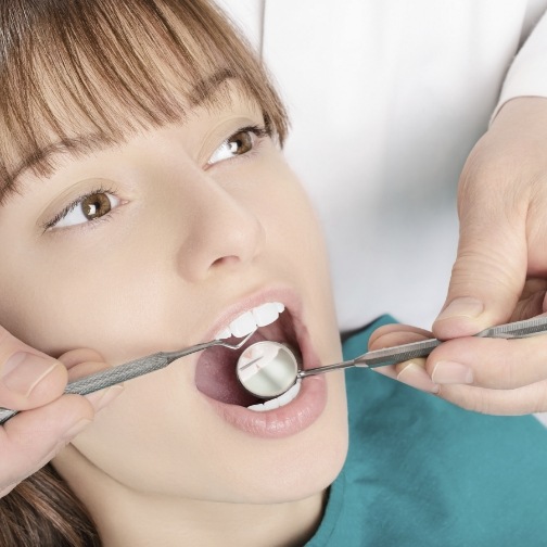 Young woman receiving a dental checkup in Fort Worth