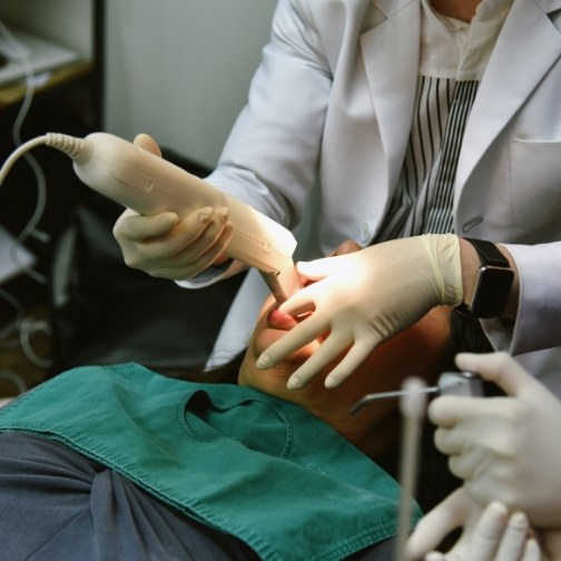 Dentist capturing digital impressions of a patients teeth