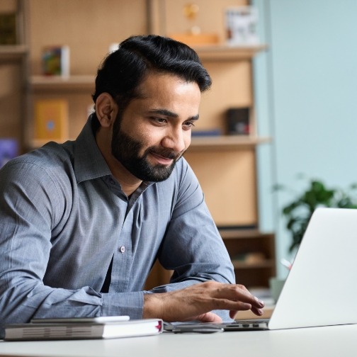 Man sitting at table and using laptop