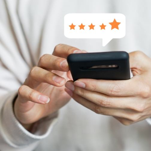 Person leaving a five star review on their phone