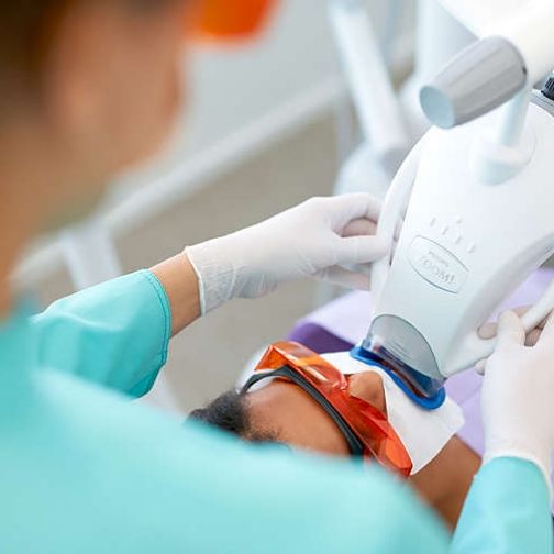 Man in dental chair receiving professional teeth whitening in Fort Worth