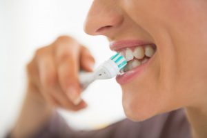 Woman brushing her teeth.