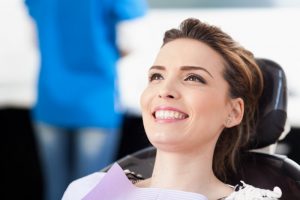 Woman smiling in dental chair. 