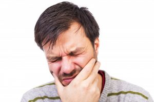 Man experiencing dental pain. 