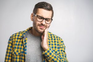 Man experiencing dental pain.