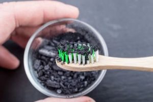 A toothbrush covered in charcoal