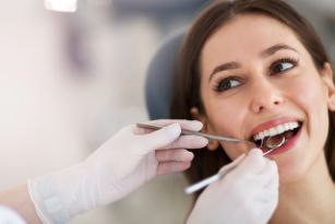 Woman with brown hair seeing a dentist for an Invisalign consultation