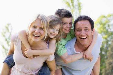 A family smiling after seeing the dentist