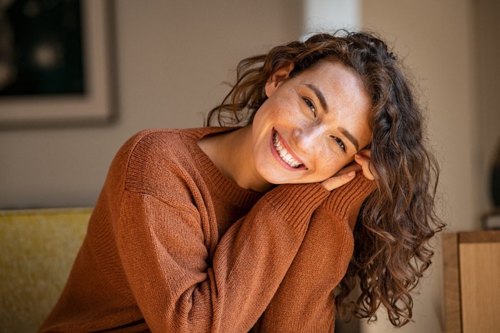 Closeup of woman in sweater smiling
