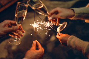 Clinking glasses together; sparklers for the new year