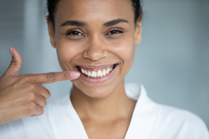Showing off front teeth replaced by dental implants